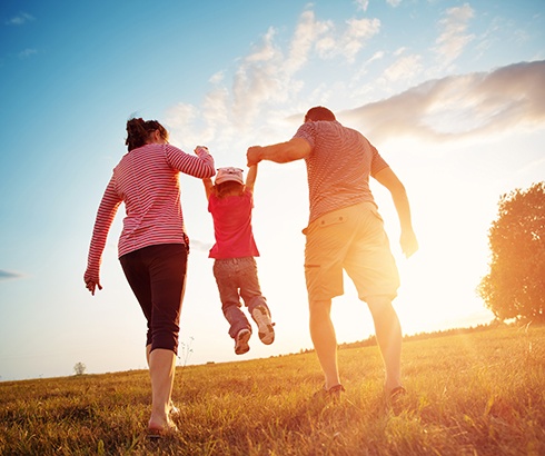 Parents playing outdoors with their child
