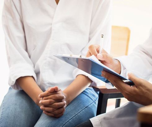 Doctor taking notes during consultation