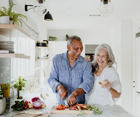 Happy senior couple preparing a meal