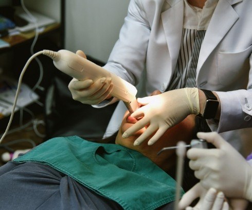 Dentist capturing digital dental impressions of a patient's teeth