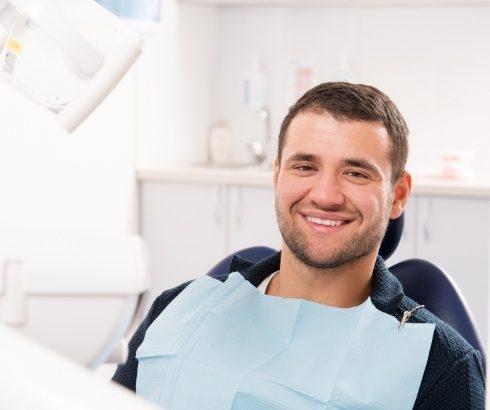 Smiling man sitting in dental chair