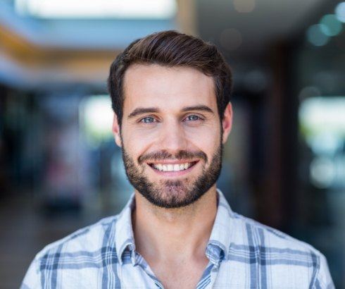 Smiling man in plaid shirt