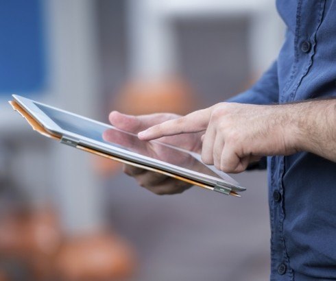 Person tapping a tablet screen