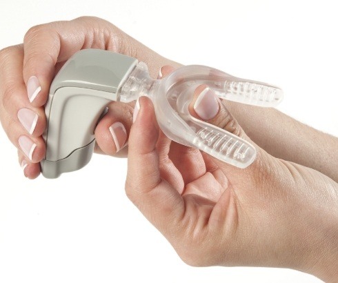 Person holding Propel orthodontic device in their hands