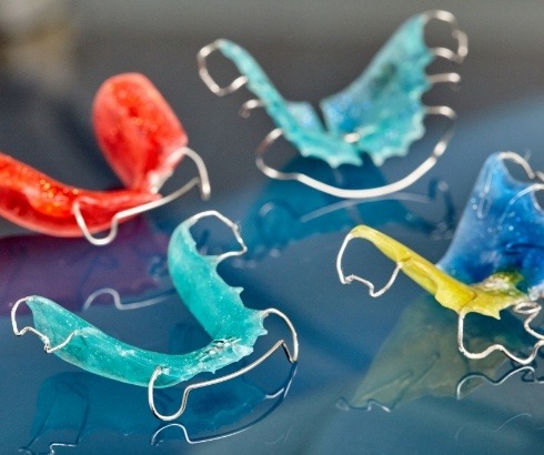 Several orthodontic retainers of different colors