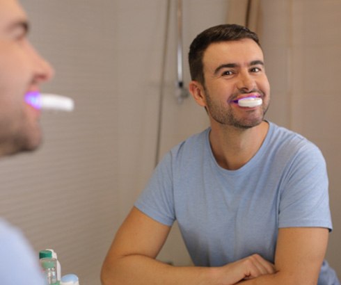Man using device that resembles OrthoPulse