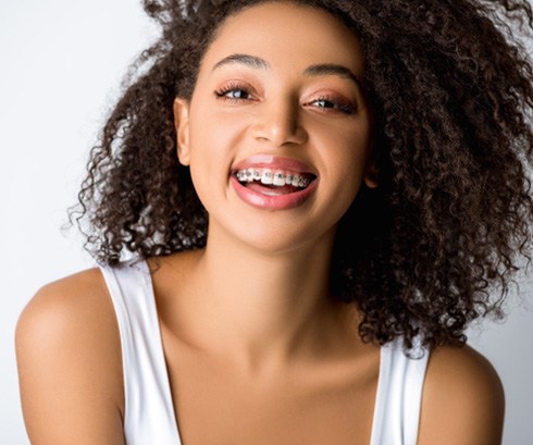 Smiling young woman with orthodontic braces