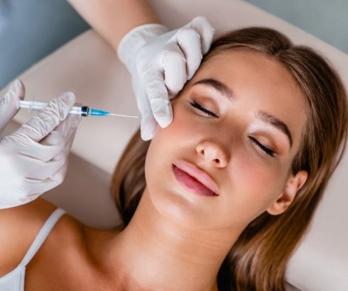 Woman with eyes closed receiving Botox injection