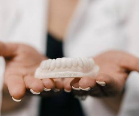 Dentist holding Myoaligner appliance in their hands