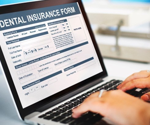 Patient looking at dental insurance form on computer screen