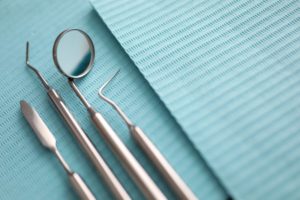 Closeup of dental tools on a blue background