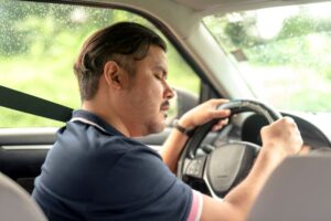 Drowsy man sitting in his car 
