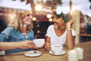 Two friends conversing in a coffee shop