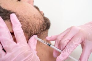 Man receiving BOTOX injection near his jaw