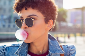 Woman blowing a bubblegum bubble 
