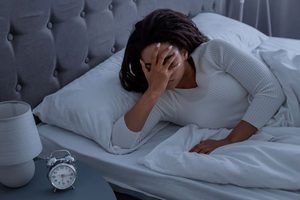 Woman waking up after night of poor sleep 