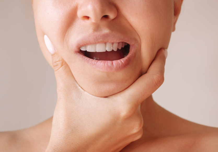 Close up of woman holding jaw